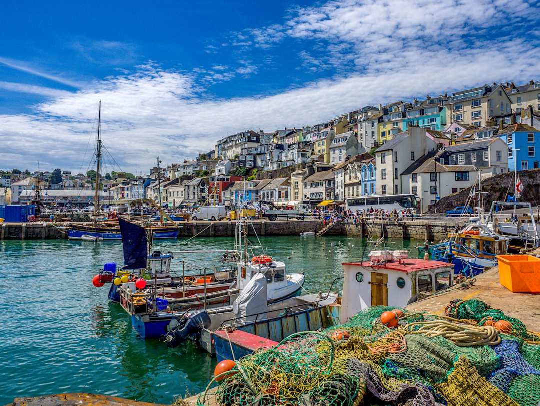 Colourful houses and fishing boats in the harbour in Brixham, Devon