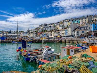 Colourful houses and fishing boats in the harbour in Brixham, Devon