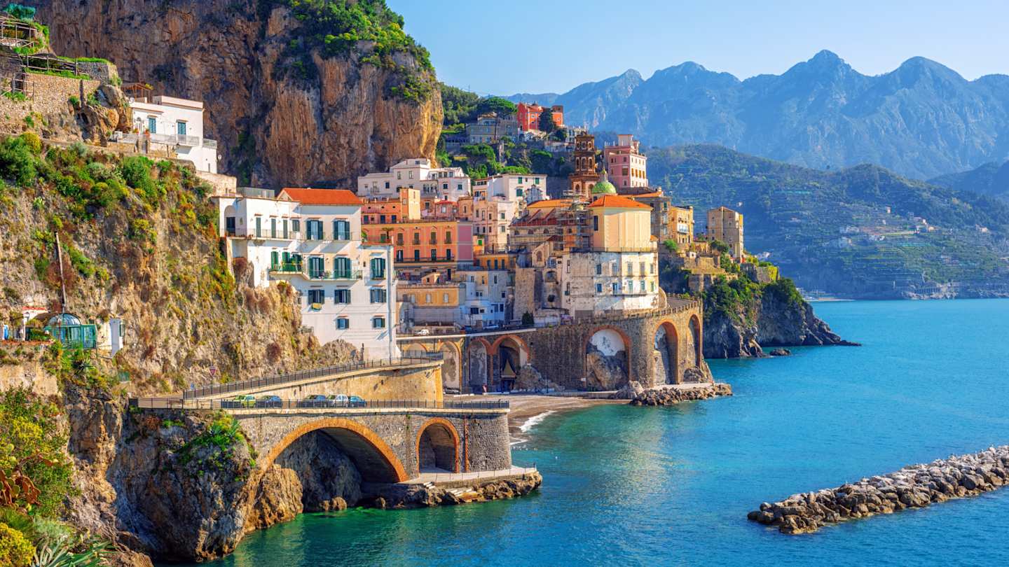 Clustered buildings on the side of a mountain by the sea, Atrani town, Amalfi coast, Sorrento, Italy