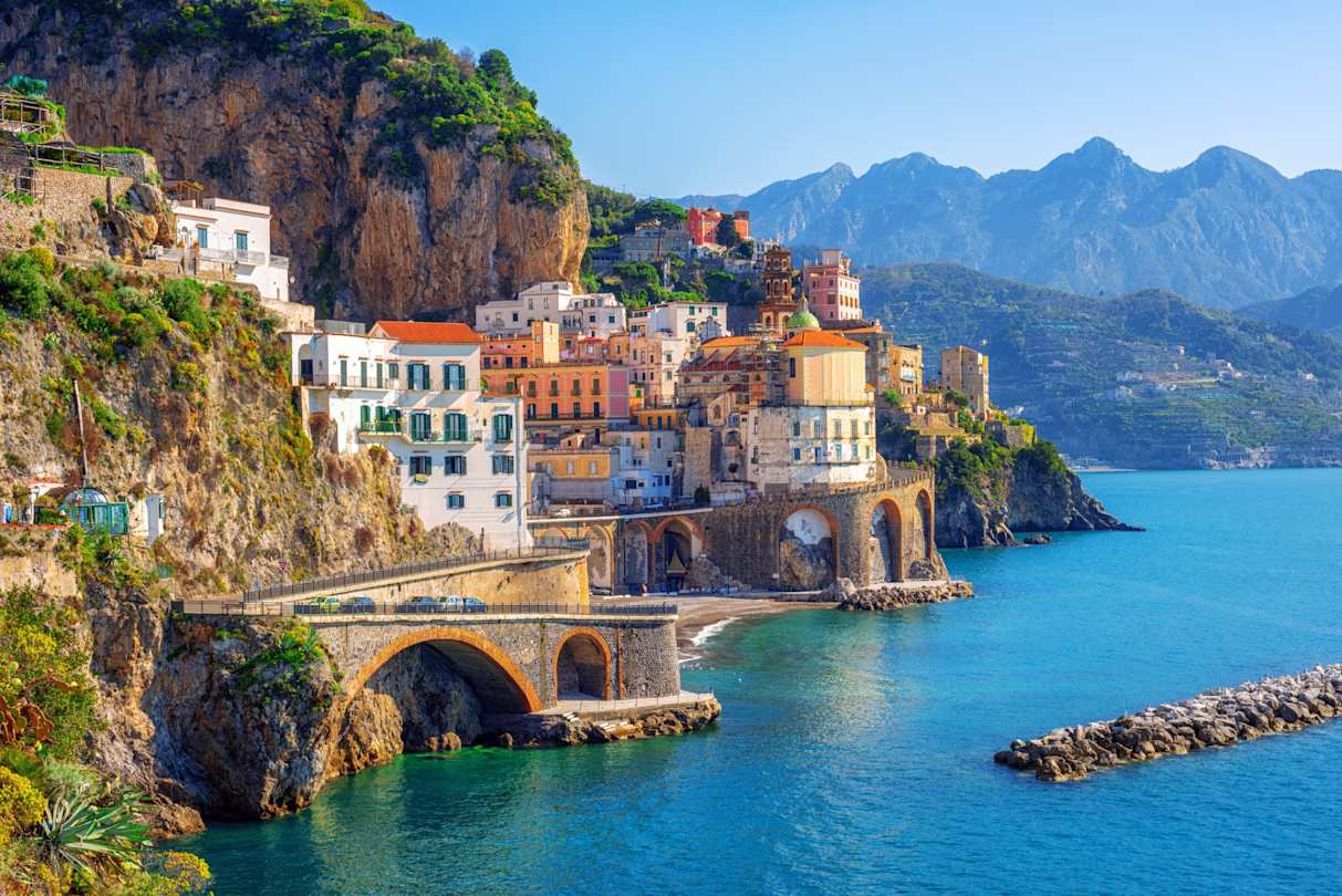 Clustered buildings on the side of a mountain by the sea, Atrani town, Amalfi coast, Sorrento, Italy