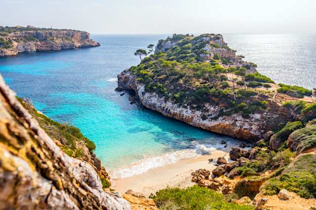 Small sandy cove surrounded by rocks, Calo des Moro beach, Mallorca