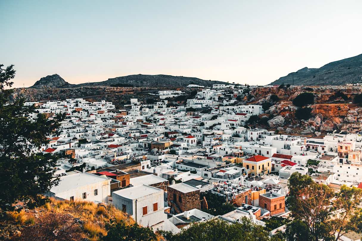 An aerial view over white buildings and distant mountains in Rhodes, Greece