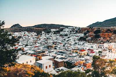 An aerial view over white buildings and distant mountains in Rhodes, Greece