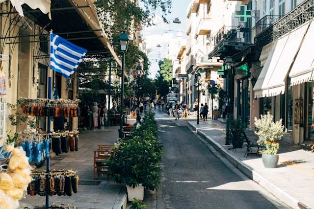 Busy, tree-lined shopping street in Athens, Greece