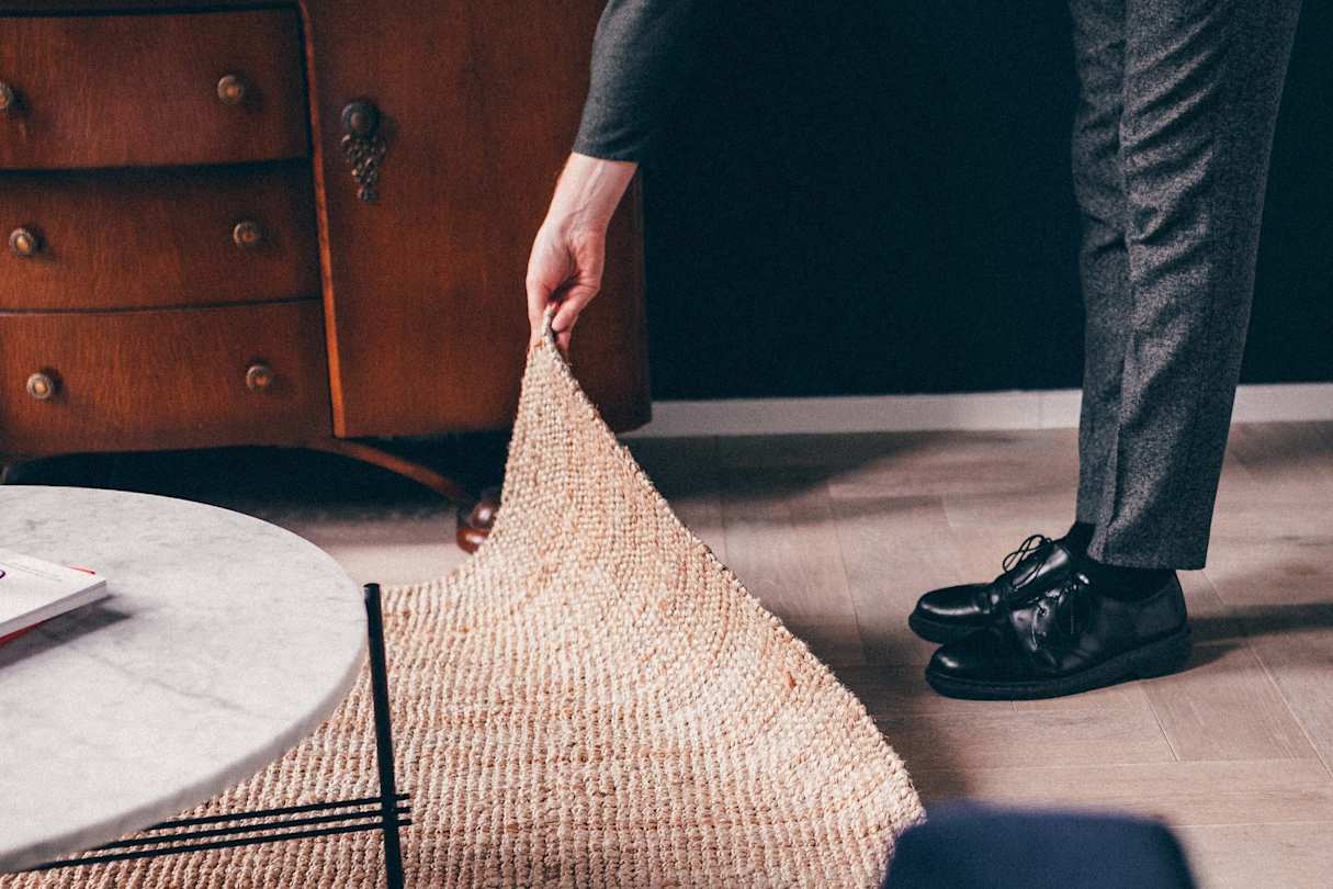a person holding a rug
