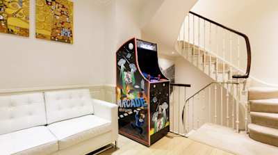 Arcade game at the bottom of a stairs