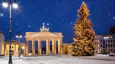 Snowy scene of Berlin at Christmas with large Christmas tree