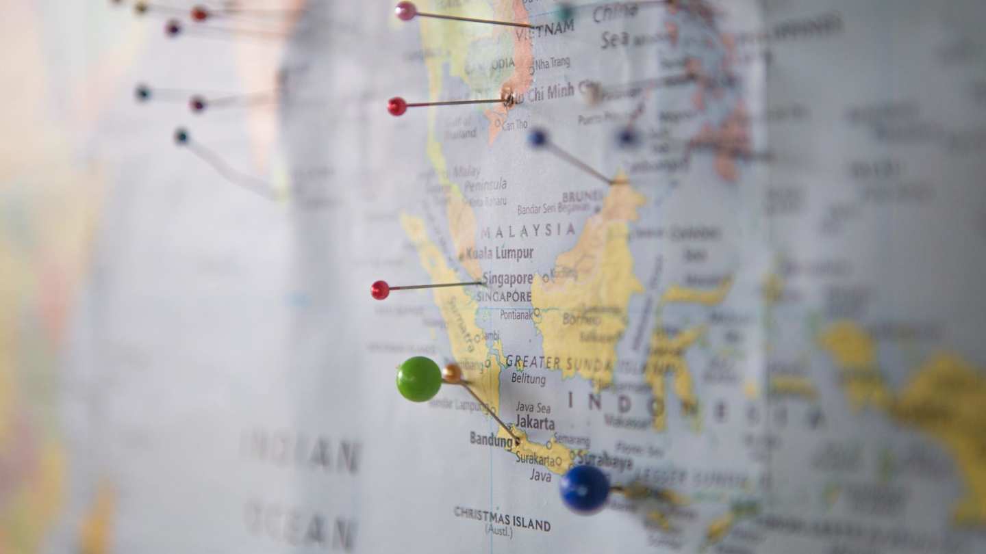 A close up of pins in a map on the wall