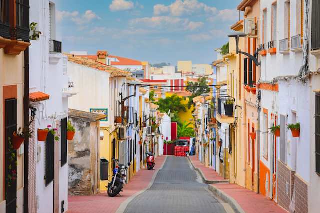 Selective focus on colourful buildings and facades on a street in Dénia, Alicante