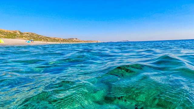 A view of a beach from within the clear blue sea, Crete, Greece