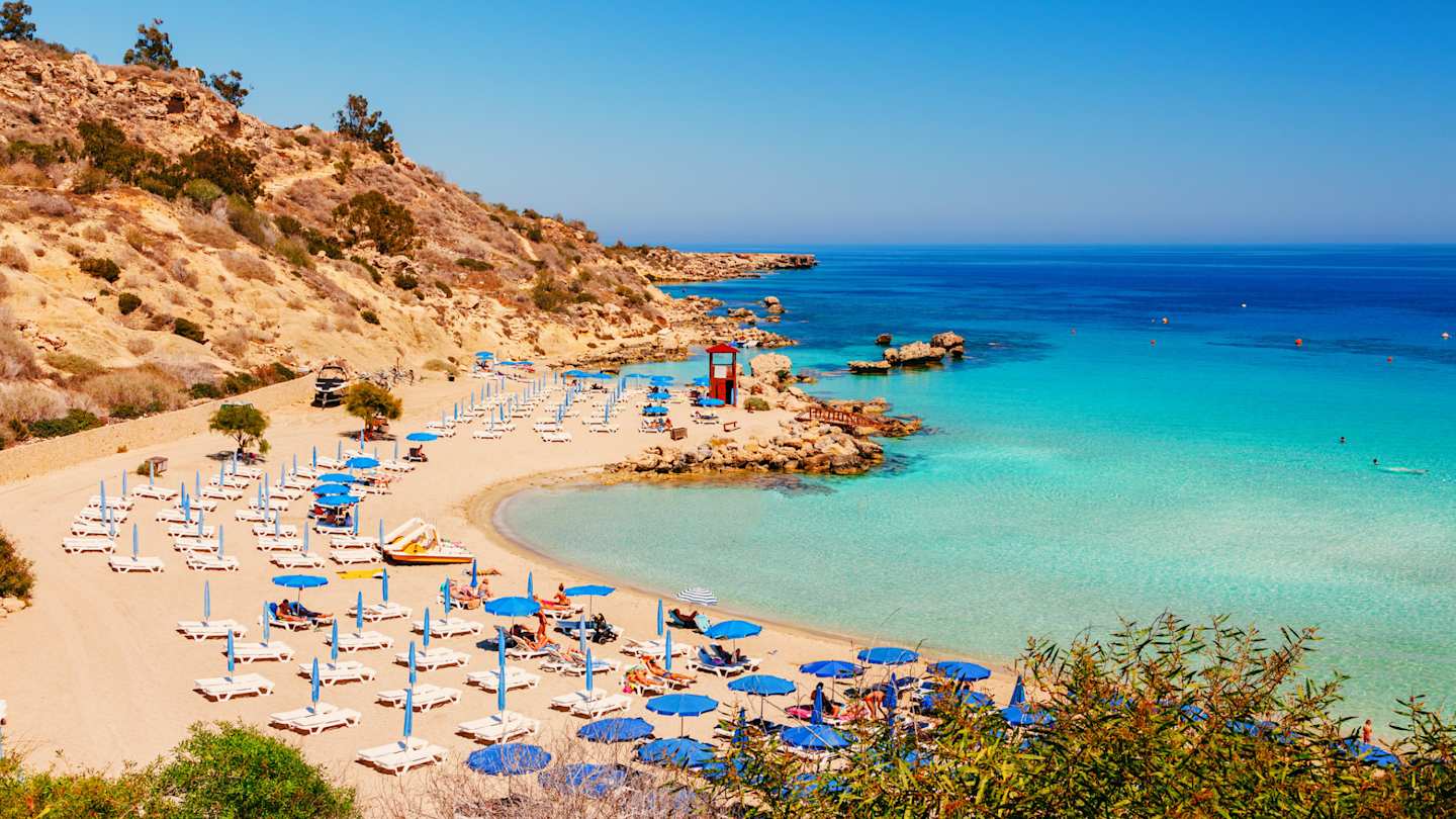 Blue-green sea and rocky beach on sunny day, Nissi beach and Cavo Greco in Ayia Napa, Cyprus