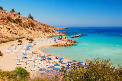 Blue-green sea and rocky beach on sunny day, Nissi beach and Cavo Greco in Ayia Napa, Cyprus