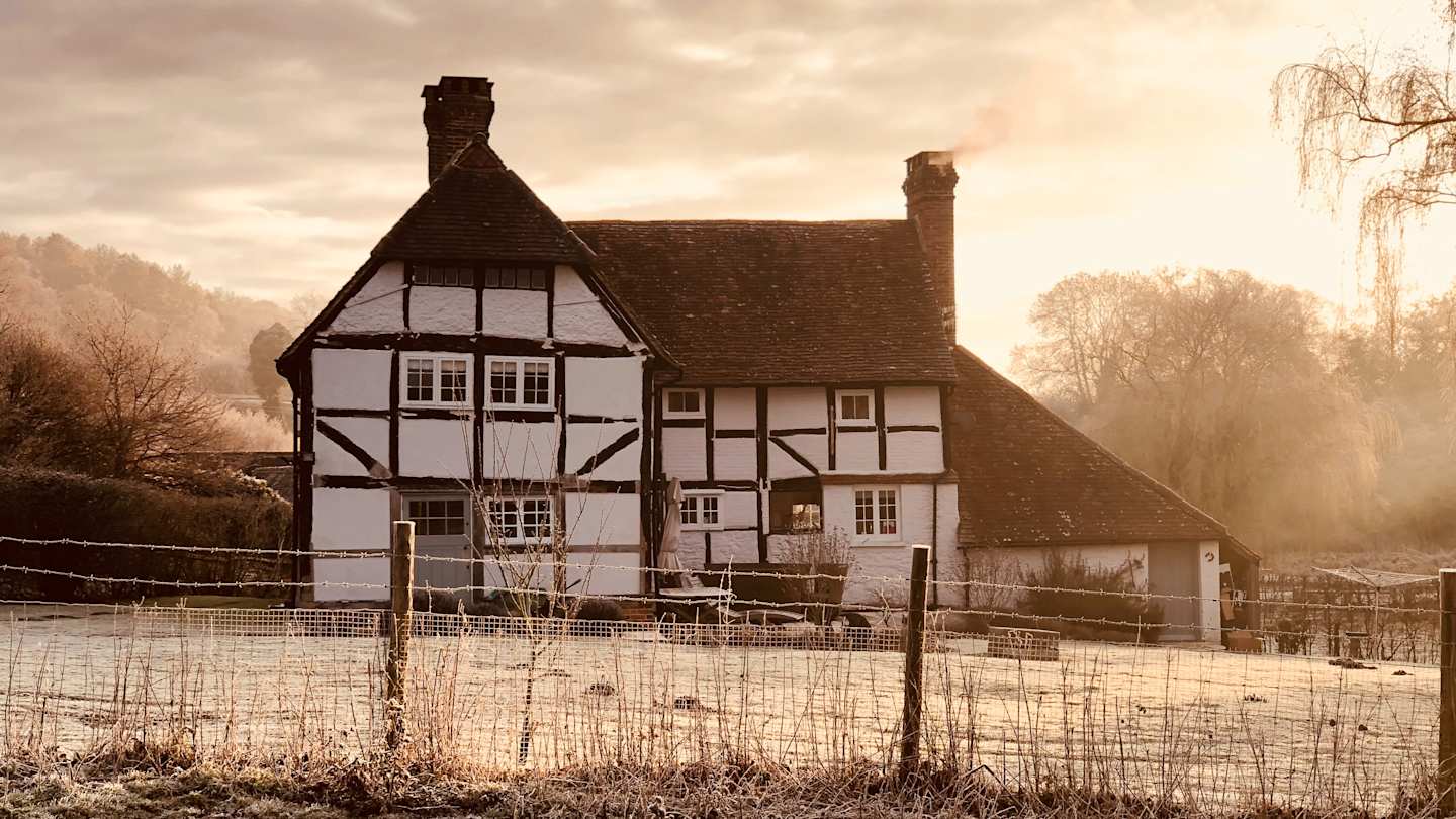 A white farmhouse on a misty morning, Surrey, UK