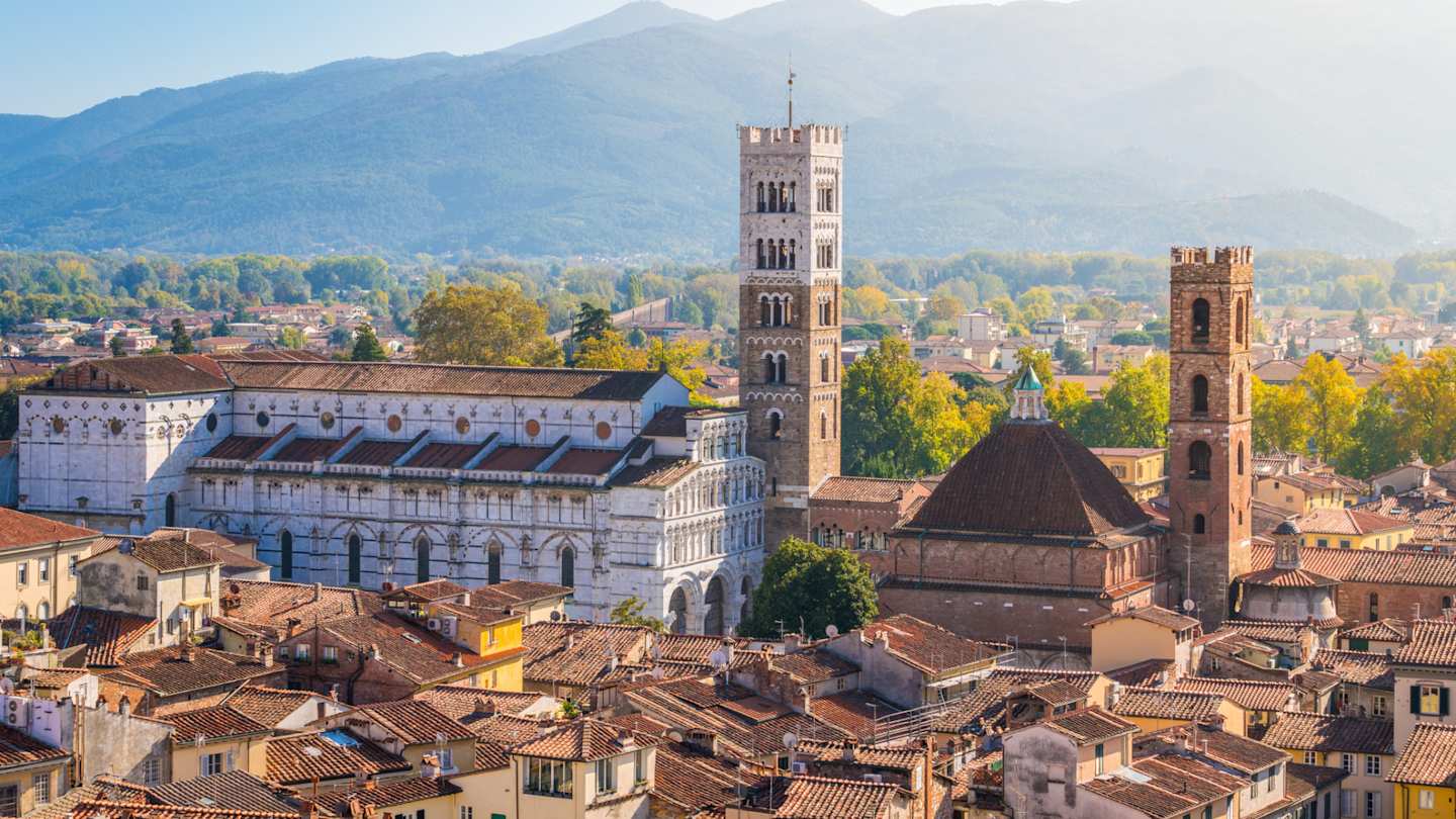 Panoramic sight in Lucca, with the Duomo of San Martino and mountains in the distance, Tuscany, Italy