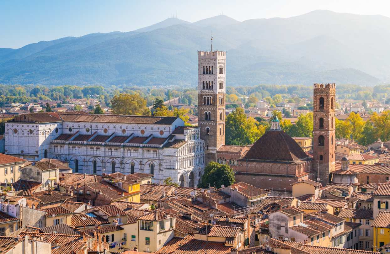 Panoramic sight in Lucca, with the Duomo of San Martino and mountains in the distance, Tuscany, Italy