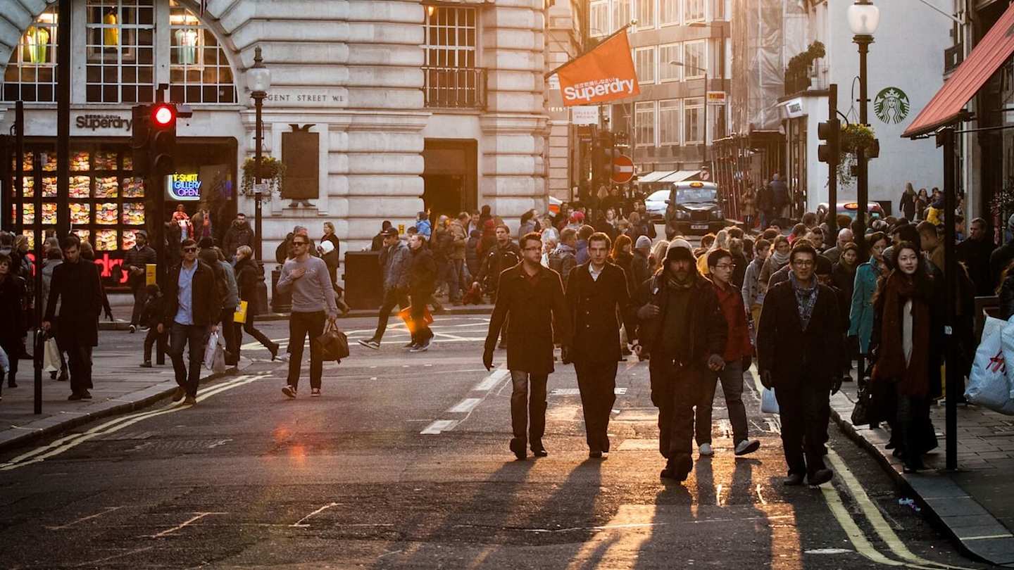 People walking through Regent Street, London, England, UK