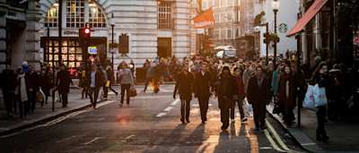 People walking through Regent Street, London, England, UK