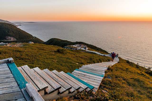 A view of a wooden path along the coast overlooking the sea at sunset, Cabot Trail, Cape Breton Highlands National Park, Nova Scotia, Canada