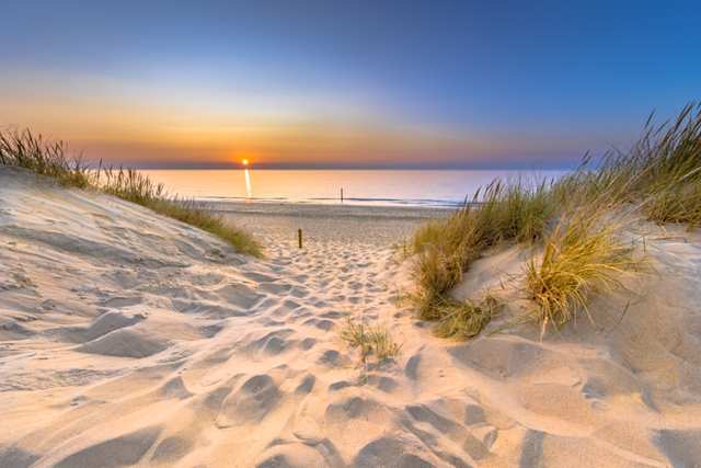 A view of soft sand at a secluded beach at sunset, Zeeland, Netherlands