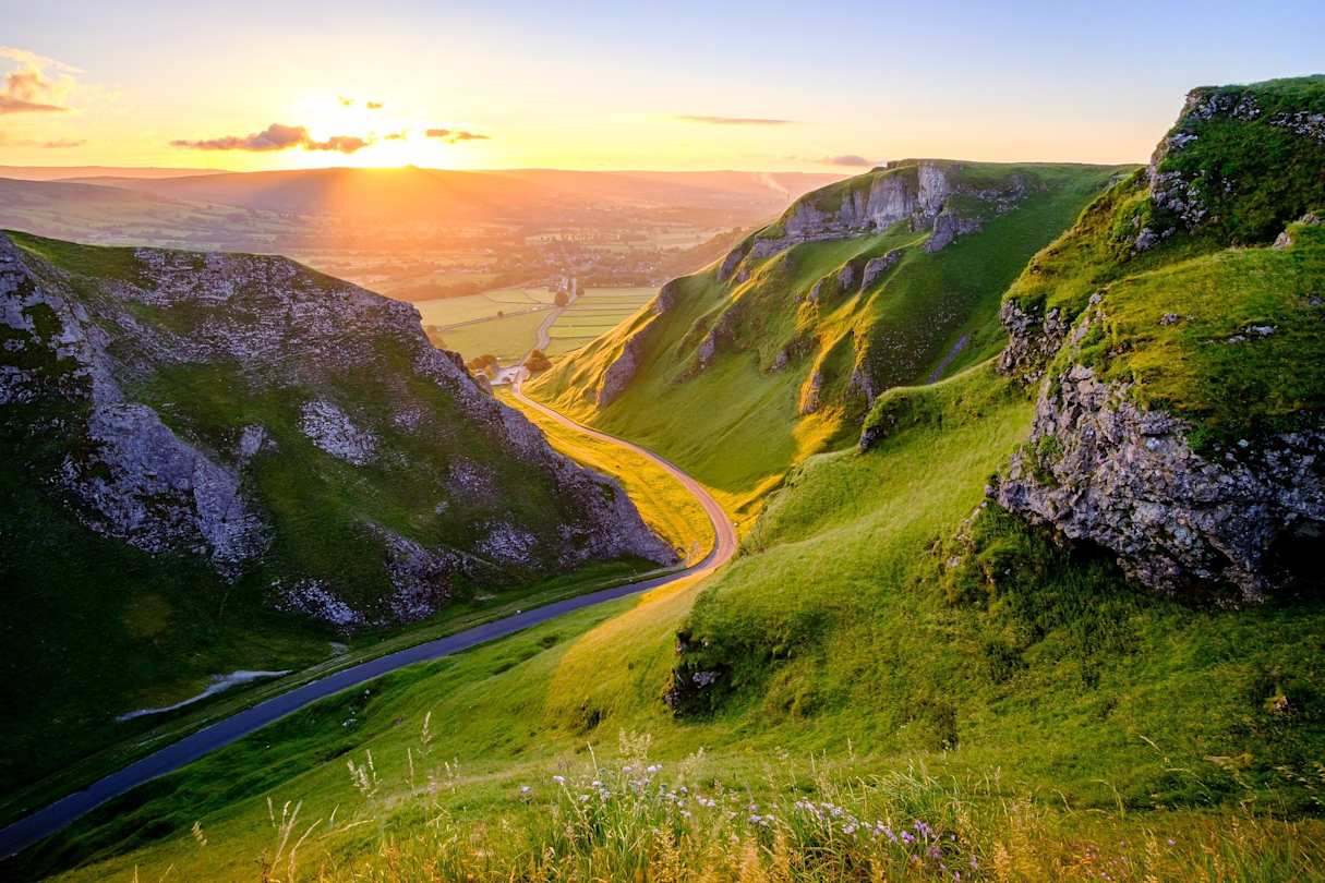 Tall green hills and mountains alongside a hiking trail in the Peak District, England, UK