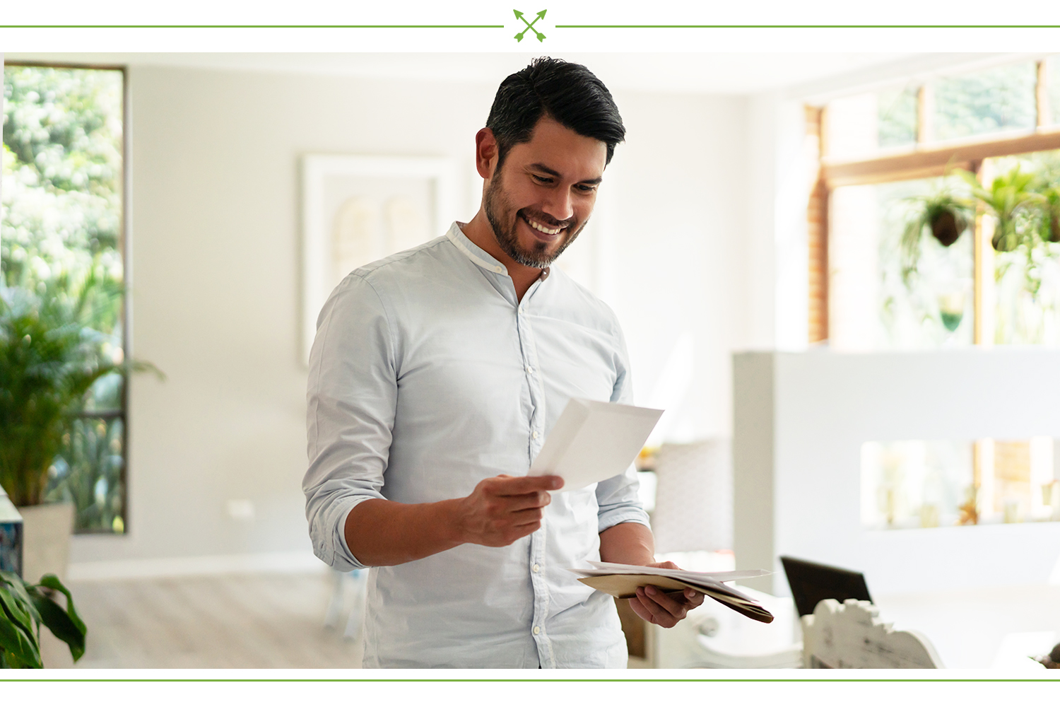 man smiling at a note from his friend