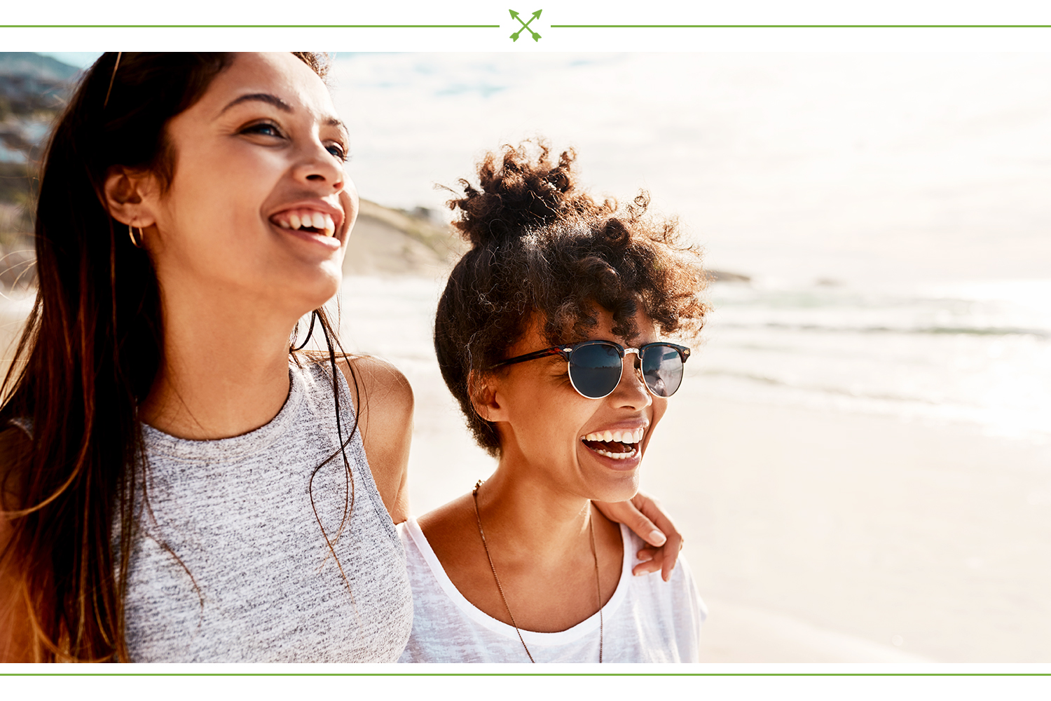 two women smiling at the beach