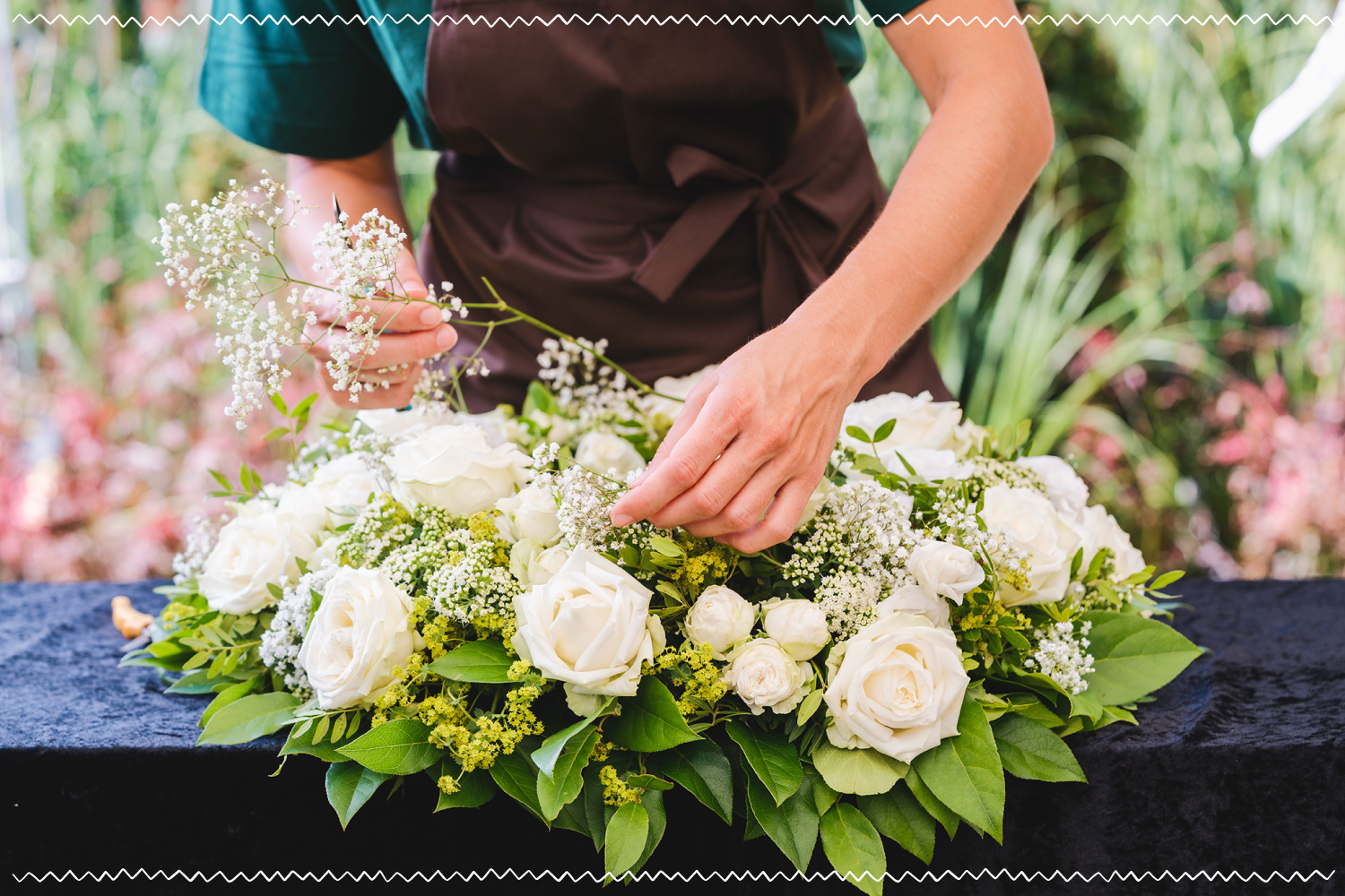 florist arranging a bouquet of white flowers