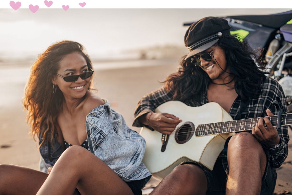 man playing guitar for woman
