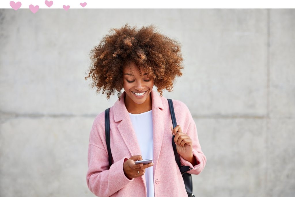 woman looking at phone and smiling
