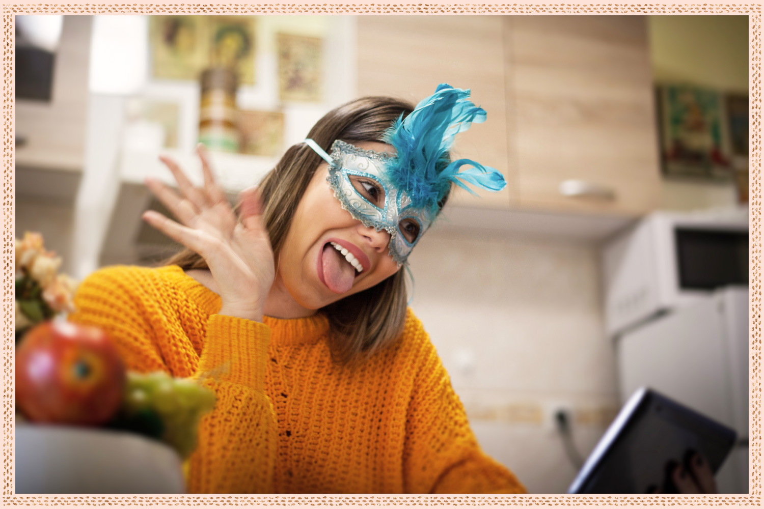 young woman with mask on sticking out her tongue and waving at tablet