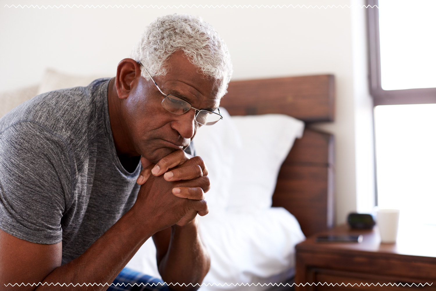 elderly man alone in bedroom grieving