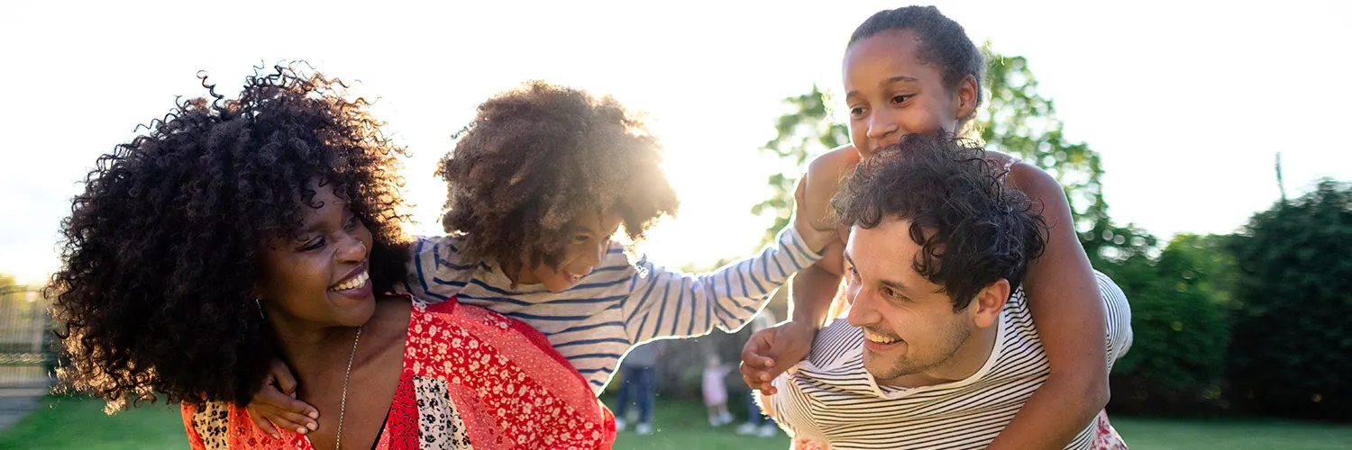 parents-playing-with-children-outside-crop