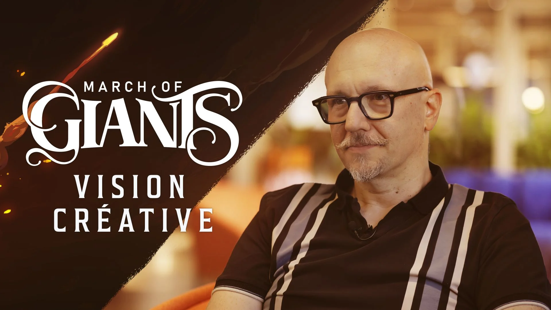 Directeur créatif Xavier Marquis avec le logo de March of Giants