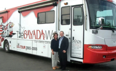 Mark and David Baiada present Colleen Thomas with an award for excellence at the 2024 bayada awards weekend