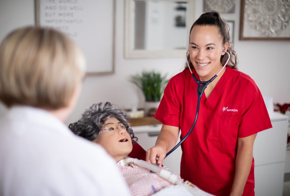 Simulation lab with Nurse listening to client heartbeat