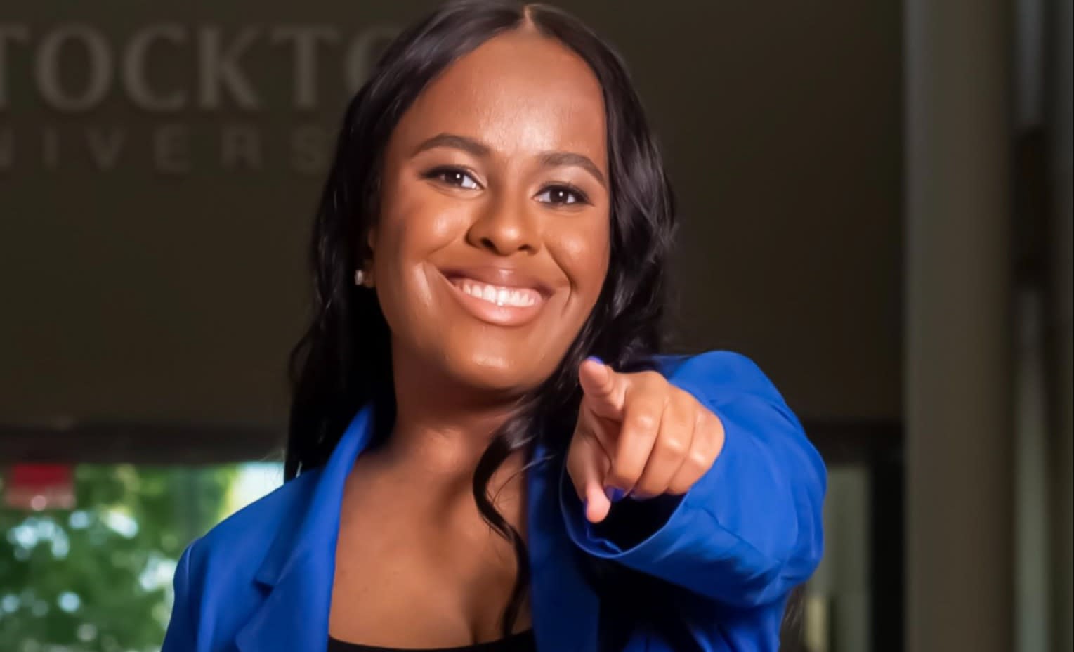 BAYADA Occupational Therapist Bria Pope Smiles as she Points to the Camera