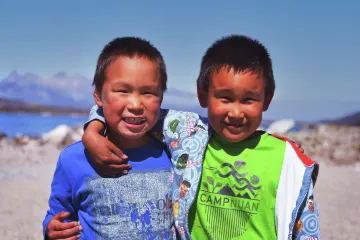 Two Greenlandic children smiling at the camera