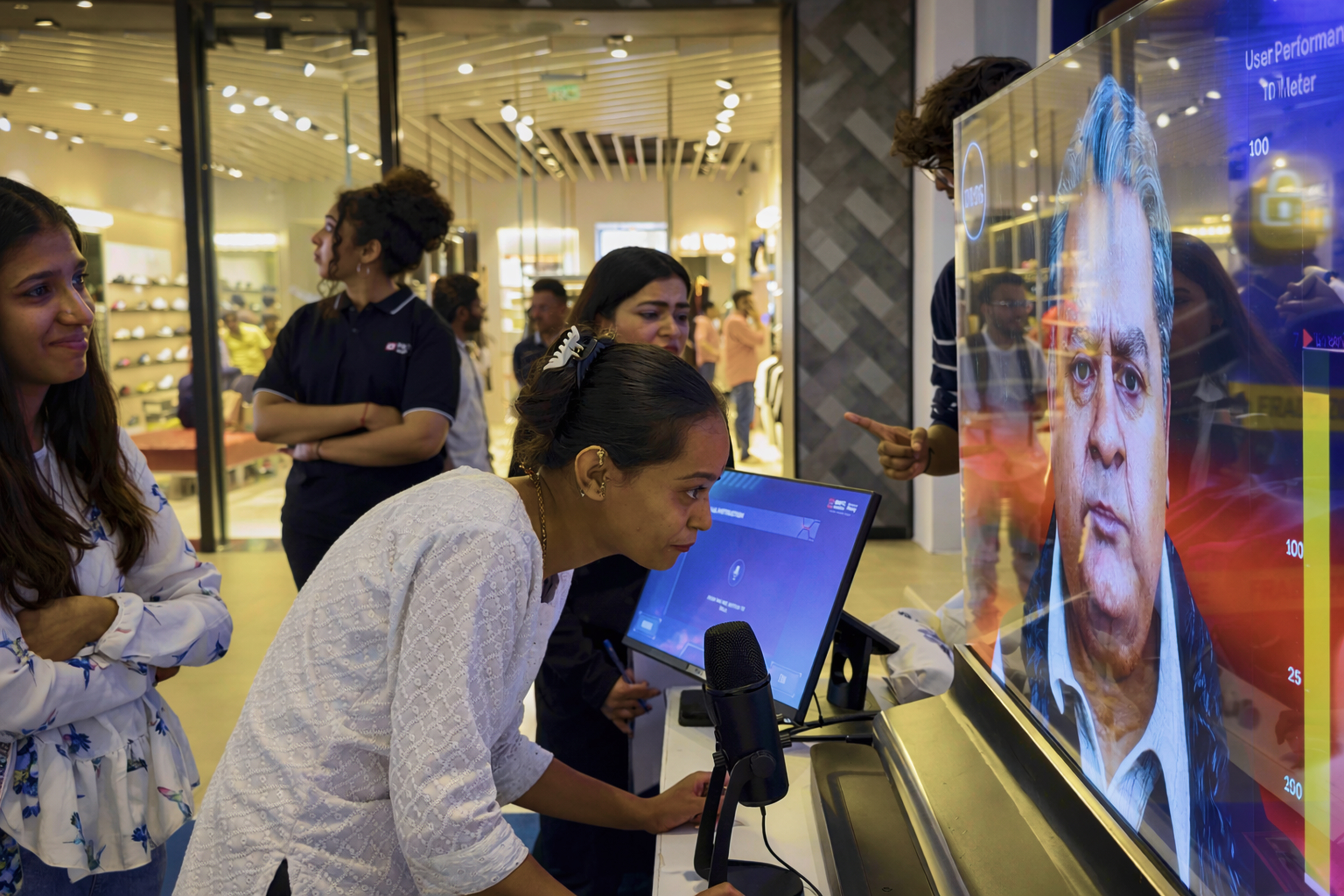 Women observing digital screen in mall