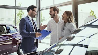 Car Dealer Talking With Customers