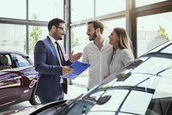 Car Dealer Talking With Customers