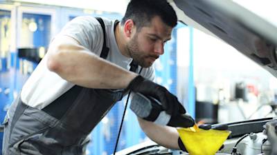 mechanic performing an oil change