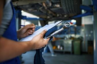 car mechanic with a maintenance schedule