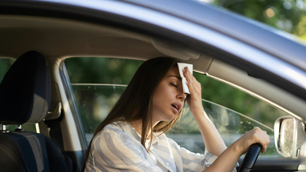 woman in hot car with broken air conditioning