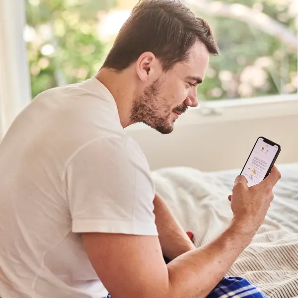 Young men writing a review on his phone