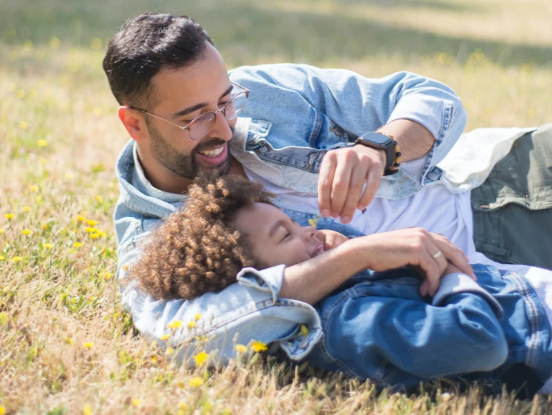 Father and son playing in the grass