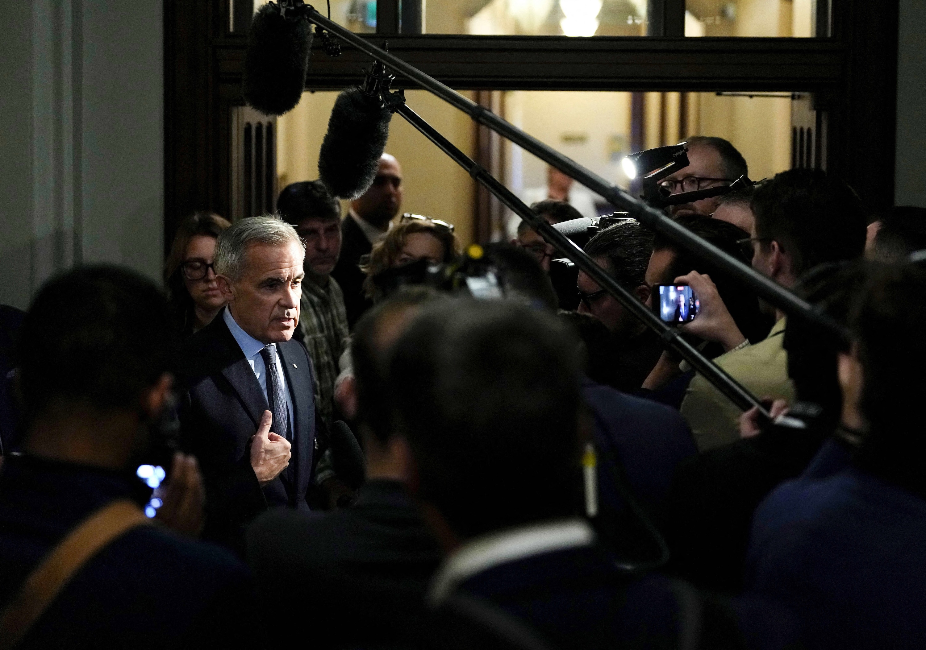 Photo: Paris Match Prime Minister Mark Carney takes questions from journalists as he arrives for a meeting of the federal cabinet on Parliament