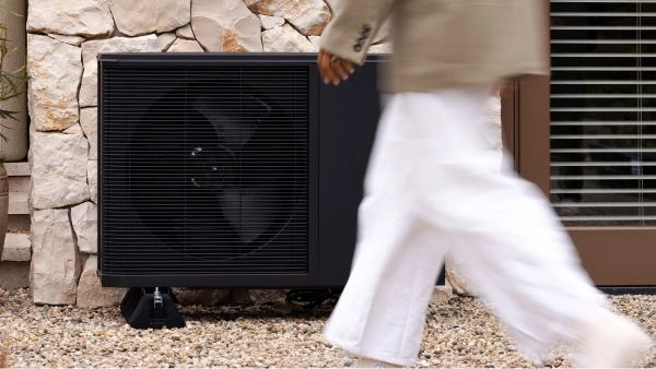 WeHeat Flint monoblock buitenunit tegen gevel aan persoon loopt er voor langs