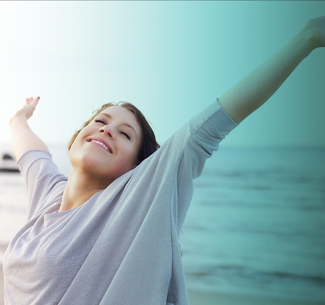 Woman happily raising her arms