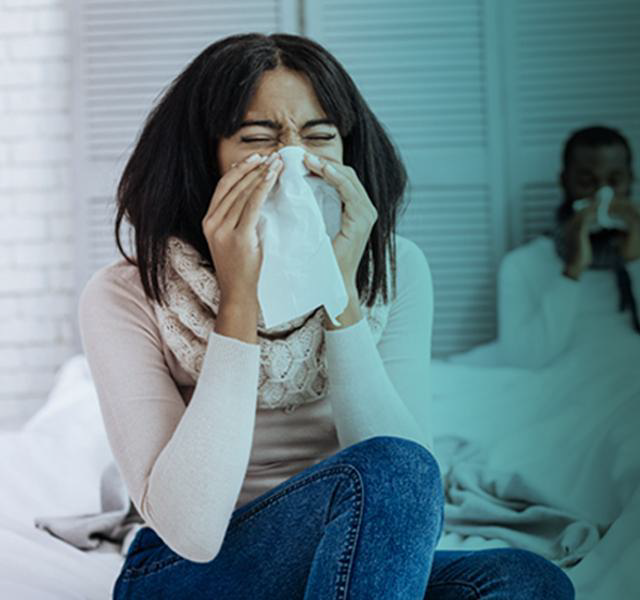 Woman and man blowing nose