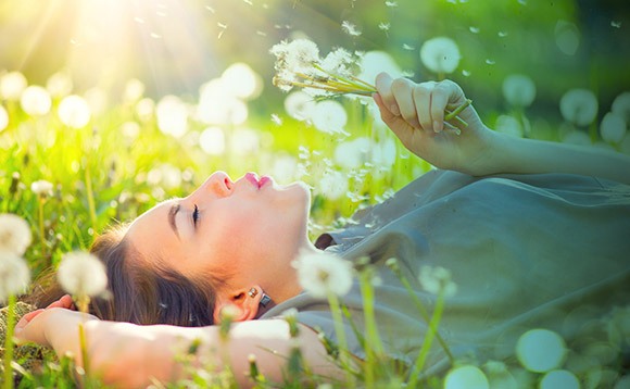Person laying down smelling flowers (pollens)